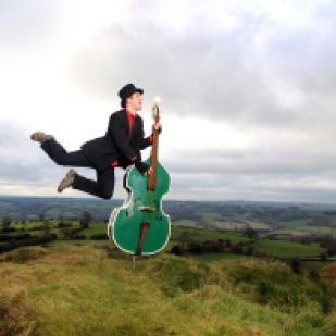 Giles Robinson pictured practicing his double bass at Alport Heights in Derbyshire.
