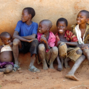 Boys living in a Tanzanian leper village where people are without adequate food, shelter or medicine.