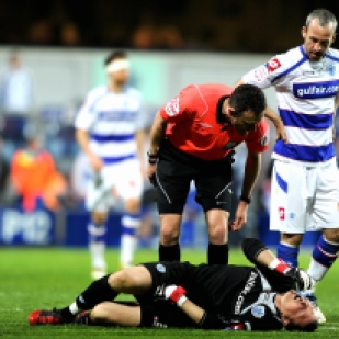 QPR's Paddy Kenny sustains an injury.