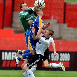 Derby County's goalkeeper Ross Atkins reaches for the ball during a game against Shrewsbury Town.